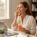 Woman taking STEADY Electrolyte Gummies at her desk for steady afternoon energy